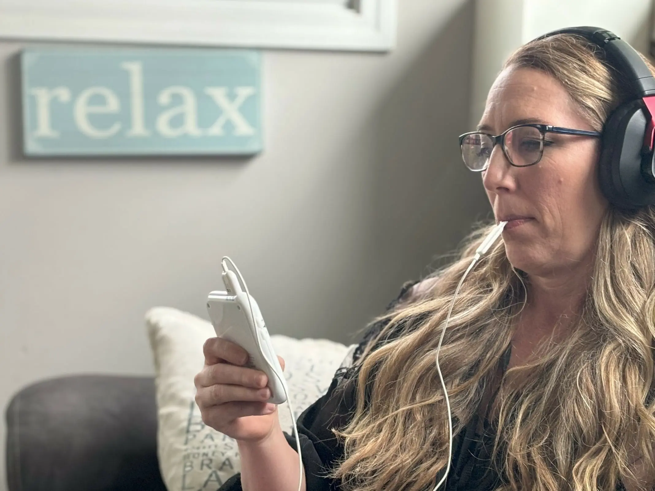 Woman using Genius Brain Signal audio frequencies to reduce stress and brain fog